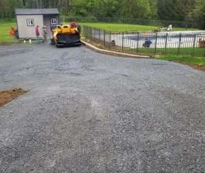 A construction crew is working on a driveway.