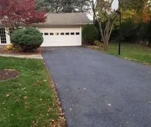 A driveway with a basketball hoop and a basketball hoop.