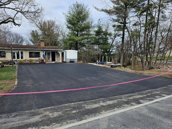 A newly paved driveway in front of a house