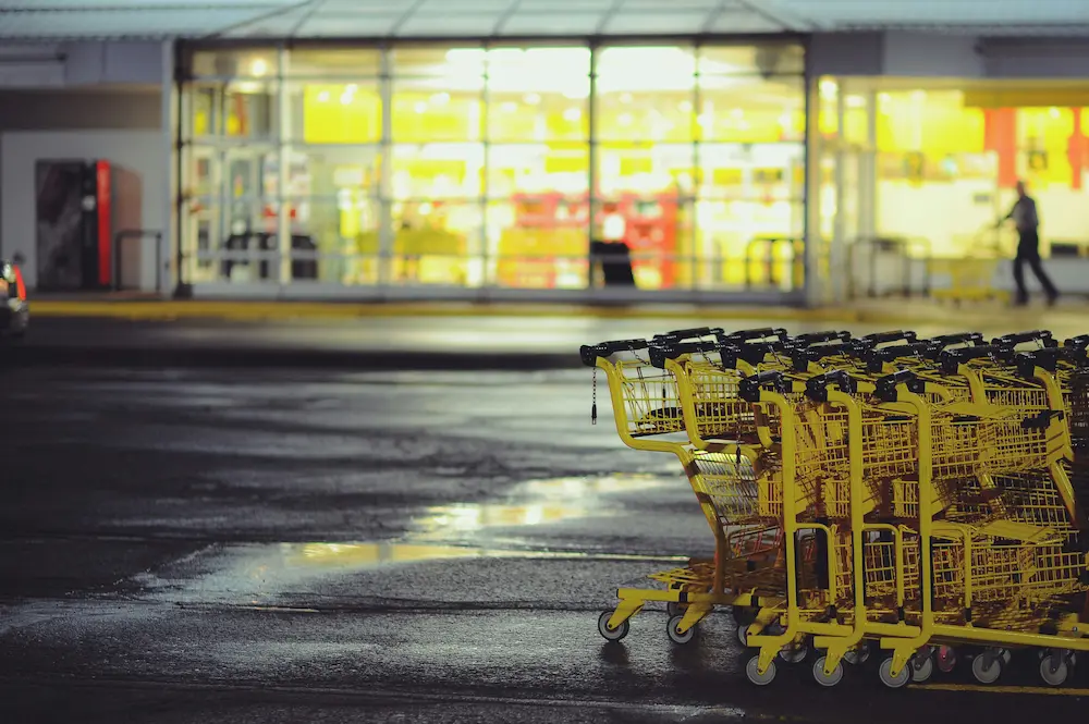 Yellow shopping carts parked in front of a store.|An isometric view of a sealcoated parking lot.||An isometric view of a sealcoated parking lot.|A sealcoated parking lot in isometric view.|An aerial view of a sealcoated parking lot.