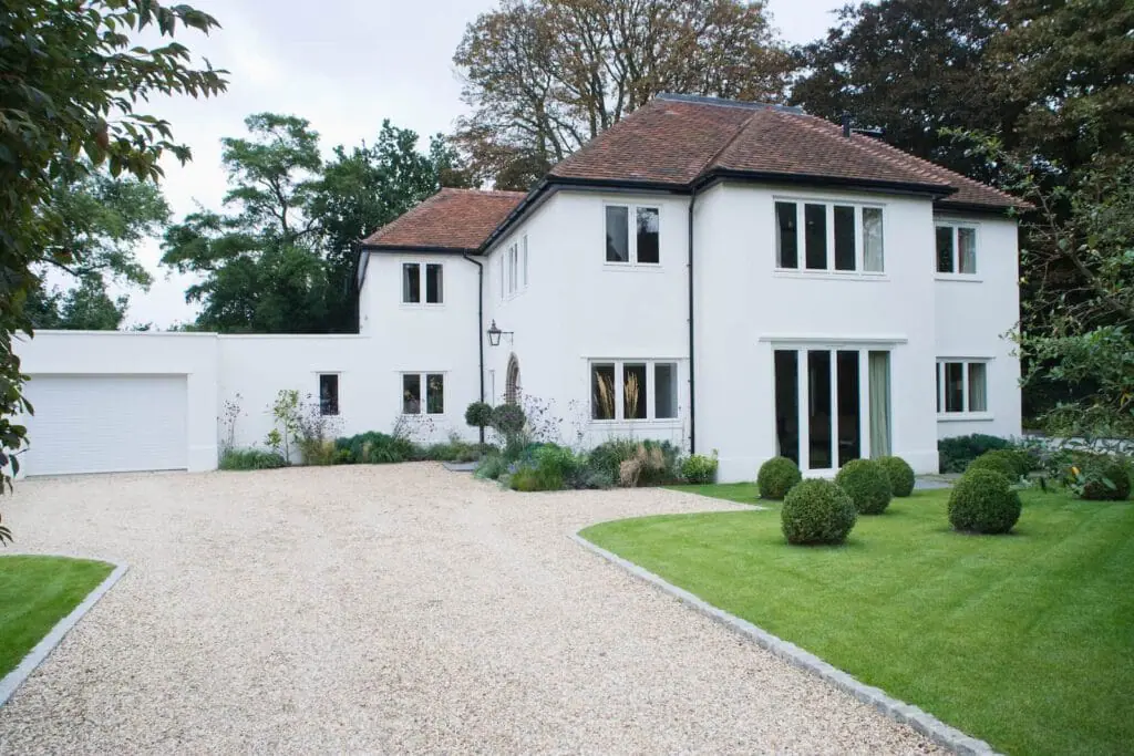 Big white house with a gravel driveway