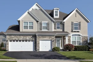 gray house with a black asphalt driveway and two garages|Big White House With A large Asphalt Driveway