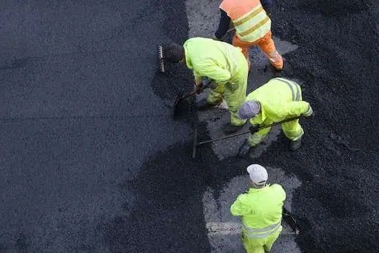 Paving experts working on a road in Lemoyne, PA, with machinery in action.