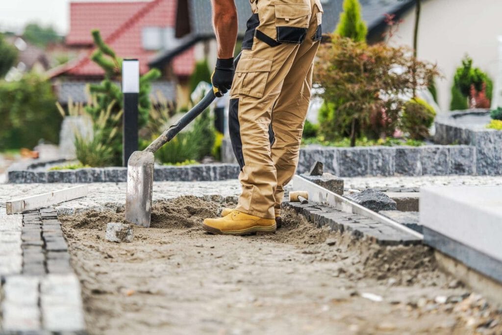 Paving contractor laying a brick paving path