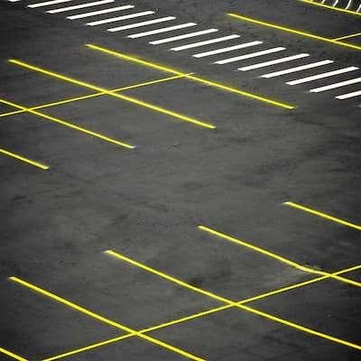 Parking lot Installation|An empty parking lot with yellow lines.