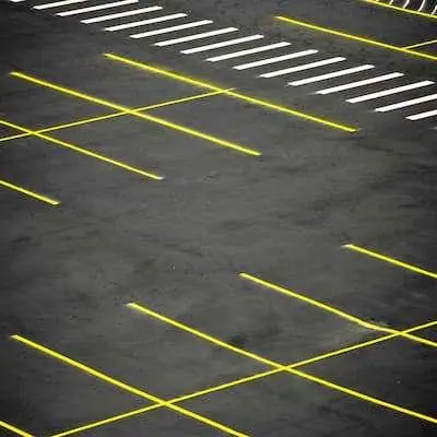 Parking lot Installation|An empty parking lot with yellow lines.