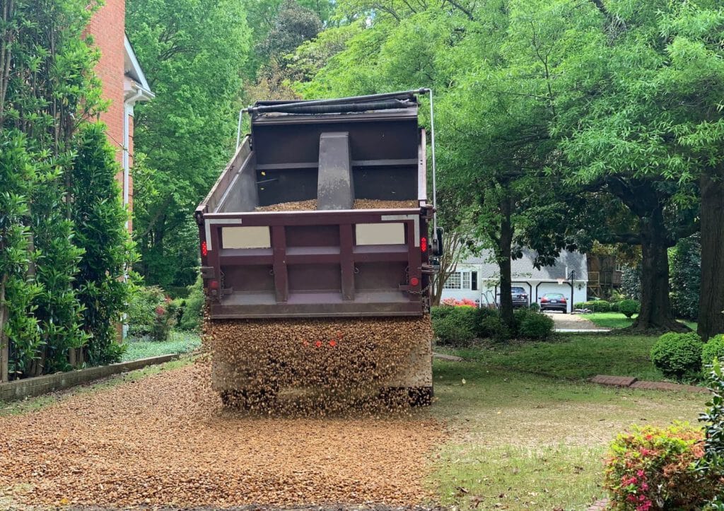 Paving Company dump truck dumping paving material for a new driveway in harrisburg pa