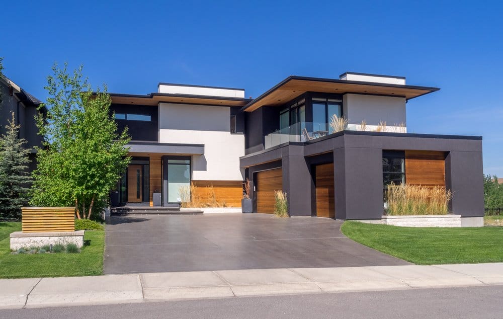 The exterior of a modern home in Calgary undergoes residential sealcoating.