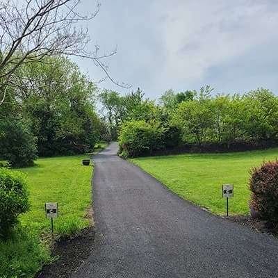 A freshly laid tar-and-chip driveway with a rustic, textured surface.