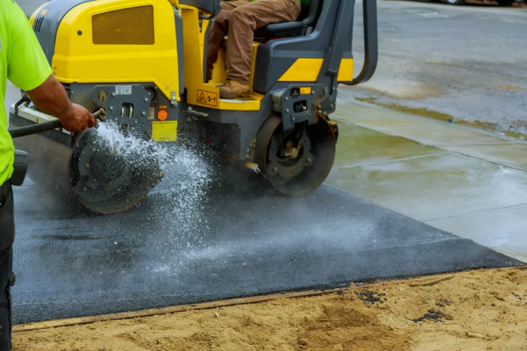 Asphalt roller compacting driveway