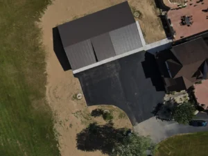 A well-finished driveway extension in Carlisle, featuring smooth gray pavers, bordered by neatly trimmed grass. The driveway connects seamlessly to the main path, enhancing the property’s curb appeal.