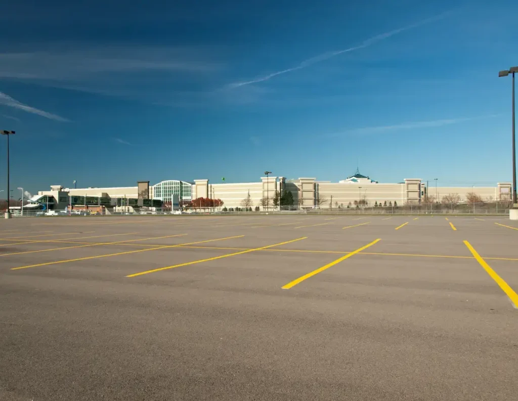 Freshly striped parking lot with clear yellow lines, providing organized and well-marked spaces for a commercial property